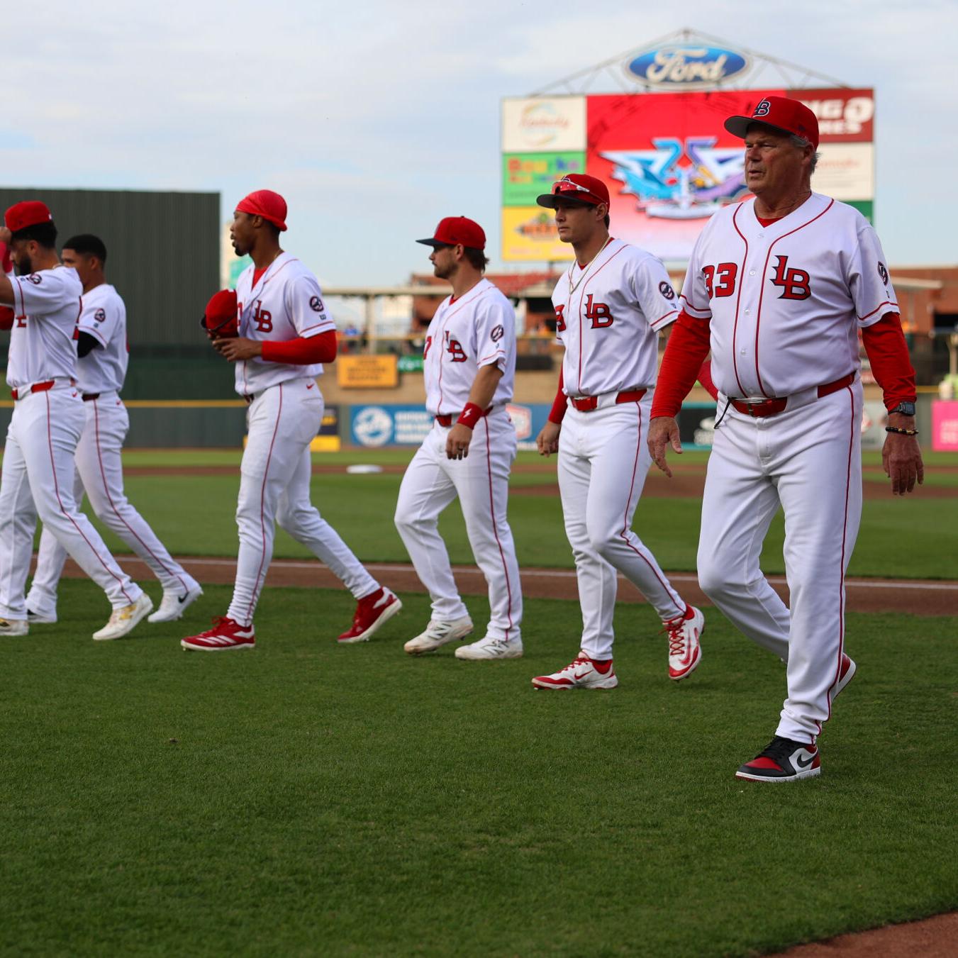 Pat Kelly walks in Louisville Bats dugout.JPG